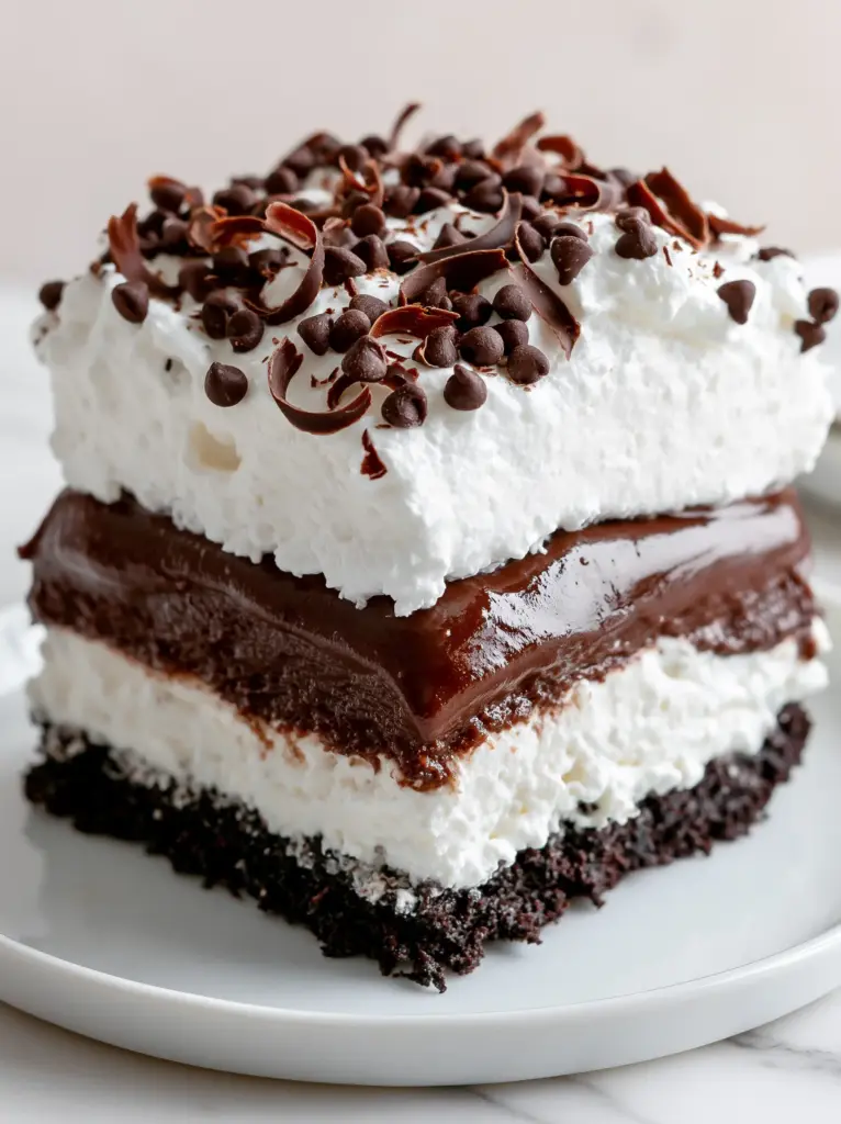 Extreme macro close-up of dark chocolate pudding and whipped cream peaks in a chocolate lasagna. (chocolate lasagna)